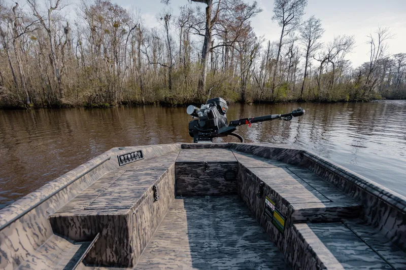 Slide: The Image of 2026 Havoc 1756 MSTC boat on a calm river, surrounded by trees. - 17