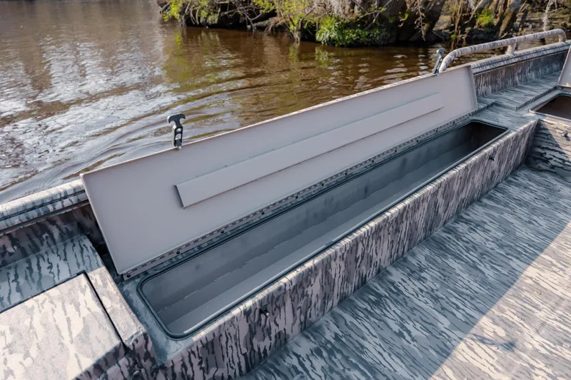 Slide: The Image of Open storage compartment on 2026 Havoc 1756 MSTC boat, near riverbank. - 20