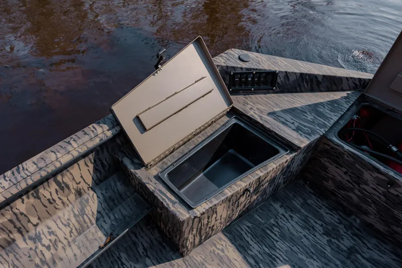 Slide: The Image of Open storage compartment on 2026 Havoc 1756 MSTC boat, near water. - 23