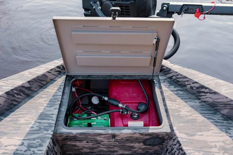 Slide: The Image of Open storage compartment in 2026 Havoc 1756 MSTC boat, revealing battery and fuel tank. - 24