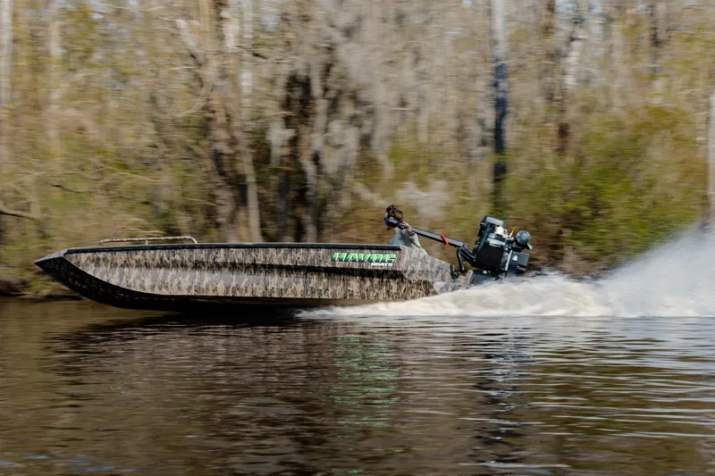 Slide: The Image of 2026 Havoc 1756 MSTC boat speeding on a river, surrounded by trees. - 3