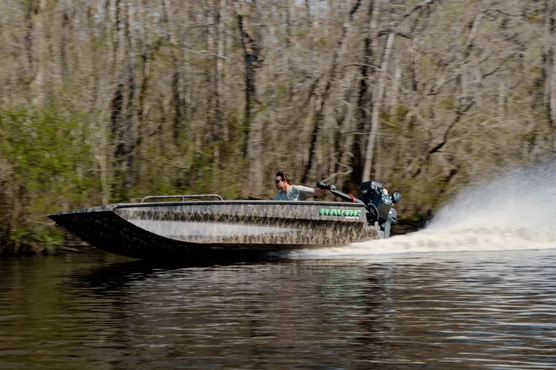 Slide: The Image of 2026 Havoc 1756 MSTC boat speeding on a river, surrounded by trees. - 4