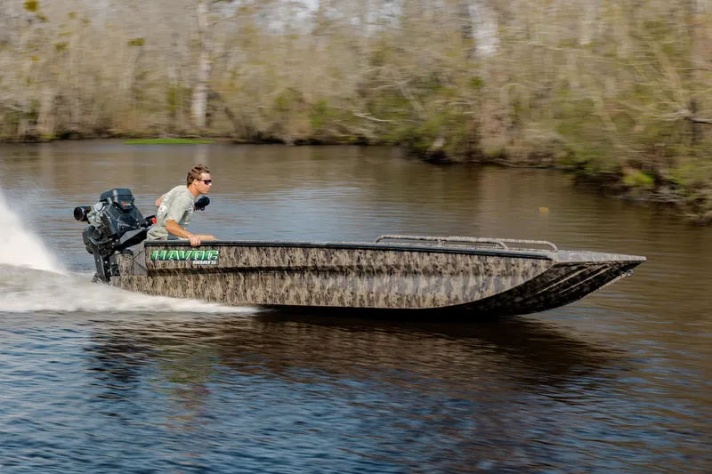 Slide: The Image of 2026 Havoc 1756 MSTC boat speeding on a river with a driver. - 6