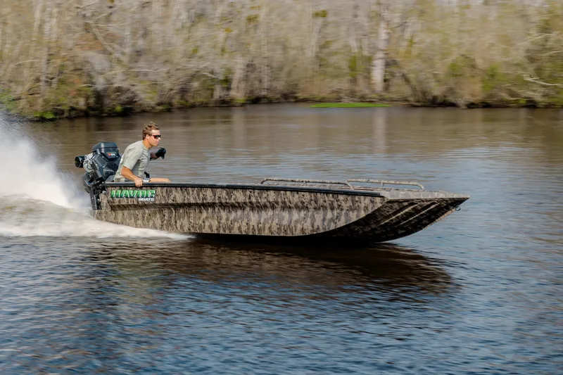 Slide: The Image of 2026 Havoc 1756 MSTC boat speeding on a river with a driver. - 7