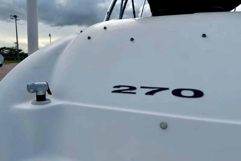 Slide: The Image of Close-up of 2004 Sea Ray 270 Sundeck boat with cloudy sky background. - 17