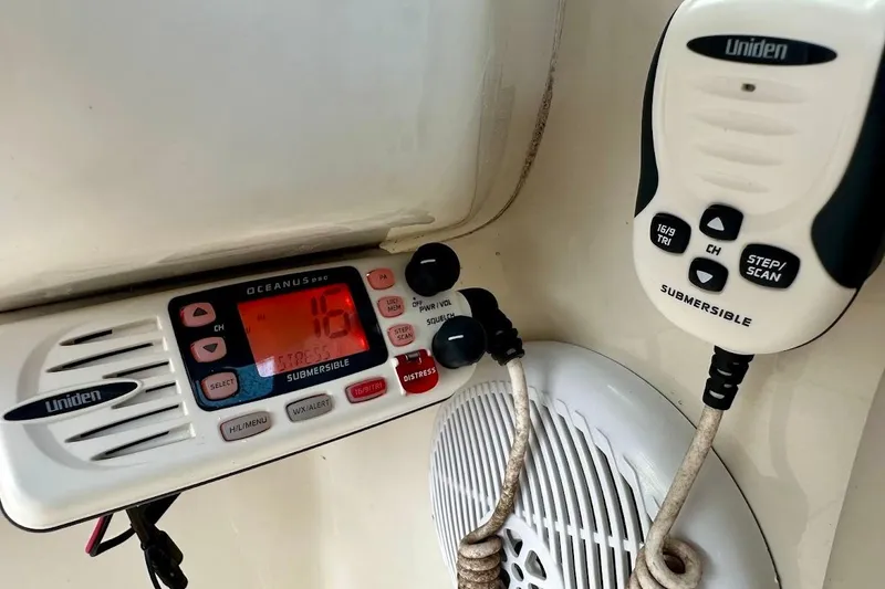 Slide: The Image of Uniden marine radio on 2004 Sea Ray 270 Sundeck, featuring distress and channel controls. - 32