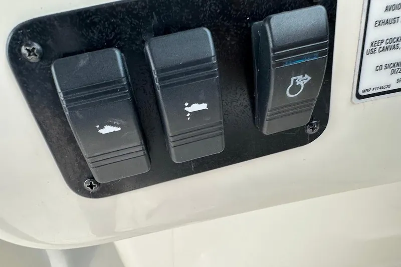 Slide: The Image of Control panel switches on a 2004 Sea Ray 270 Sundeck boat. - 44