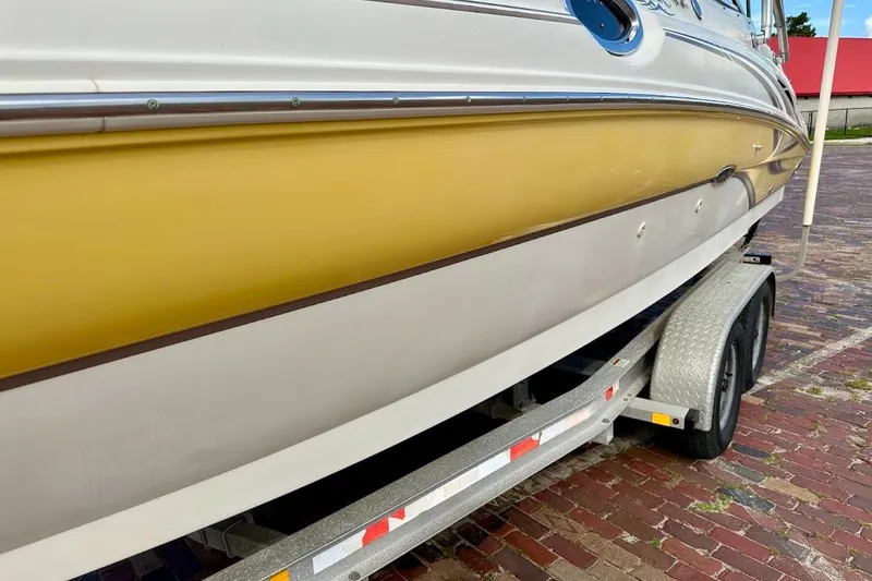 Slide: The Image of 2004 Sea Ray 270 Sundeck boat on trailer, yellow and white exterior. - 8
