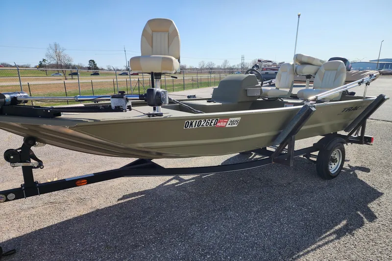 Slide: The Image of 2017 Tracker Grizzly 1648 SC boat on trailer, parked outdoors. - 3