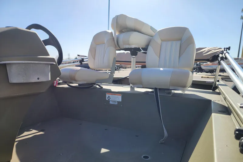 Slide: The Image of 2017 Tracker Grizzly 1648 SC boat interior with beige seats and steering wheel. - 6