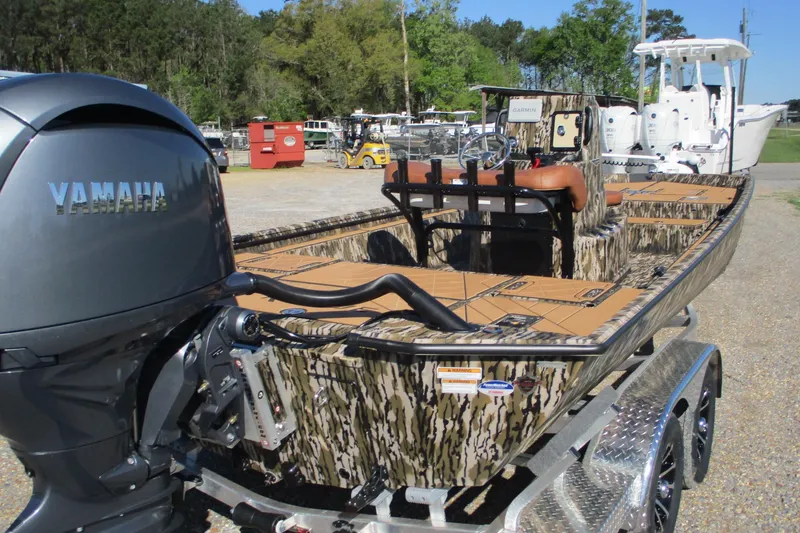 Slide: The Image of 2026 Avid 22 Rogue CC boat with Yamaha engine, camo design, on a trailer. - 10