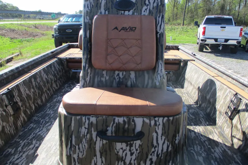 Slide: The Image of 2026 Avid 22 Rogue CC boat interior with camo design and brown seating. - 17
