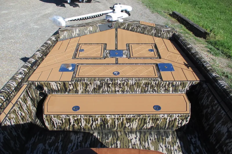 Slide: The Image of 2026 Avid 22 Rogue CC boat interior with camo design and storage compartments. - 5