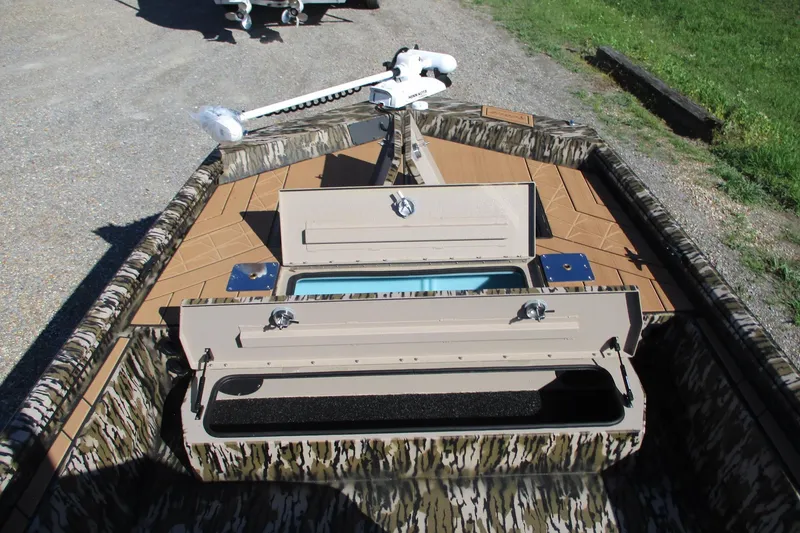 Slide: The Image of 2026 Avid 22 Rogue CC boat with open storage compartments and camouflage design. - 6