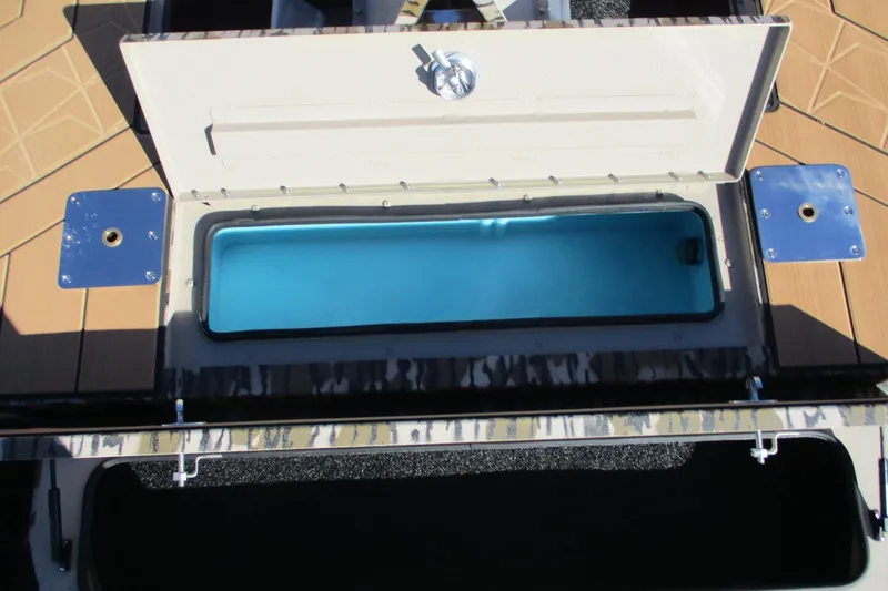 Slide: The Image of Open storage compartment on 2026 Avid 22 Rogue CC boat deck. - 7
