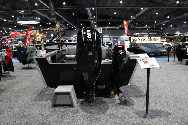 Slide: The Image of 2026 Alumaweld Columbia XL 26 boat displayed at an indoor exhibition with powerful outboard motors. - 26