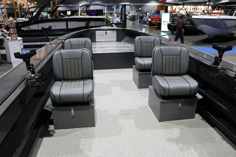 Slide: The Image of 2026 Alumaweld Columbia XL 26 boat interior with four gray seats at a boat show. - 3