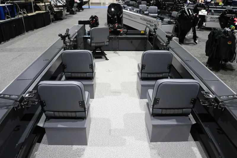 Slide: The Image of 2026 Alumaweld Columbia XL 26 boat interior with four gray seats and fishing rod holders. - 5