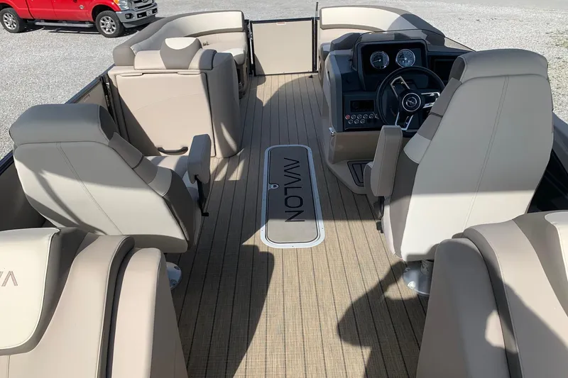 Slide: The Image of 2024 Avalon Catalina Quad Lounge interior with beige seating and modern dashboard. - 11