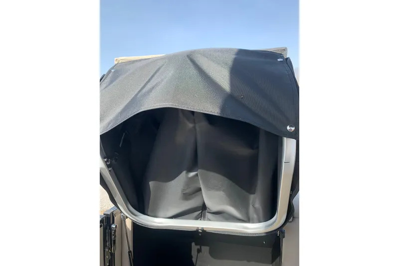 Slide: The Image of 2024 Avalon Catalina Quad Lounge 23' boat with covered storage compartment. - 15