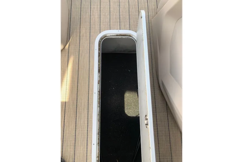 Slide: The Image of Open storage compartment on 2024 Avalon Catalina Quad Lounge boat. - 16