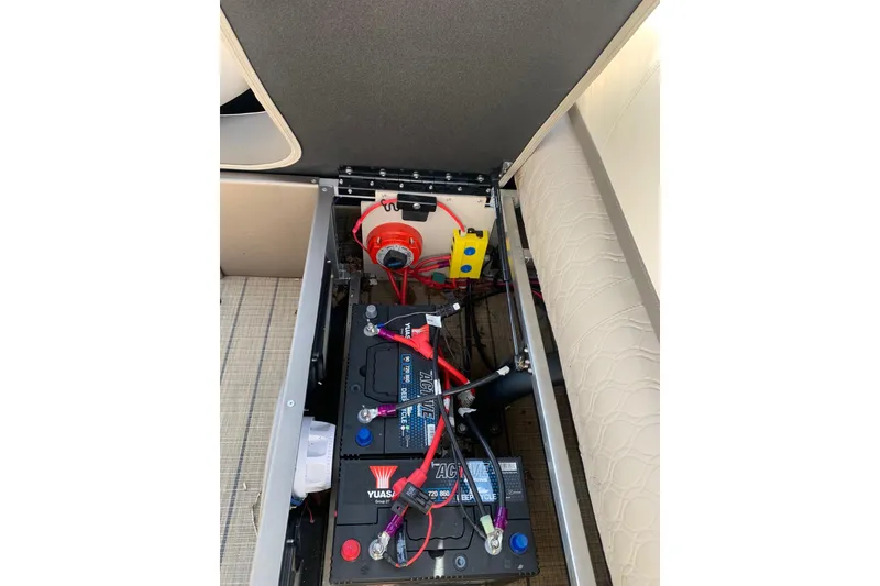 Slide: The Image of 2024 Avalon Catalina Quad Lounge battery compartment with wiring and components. - 18