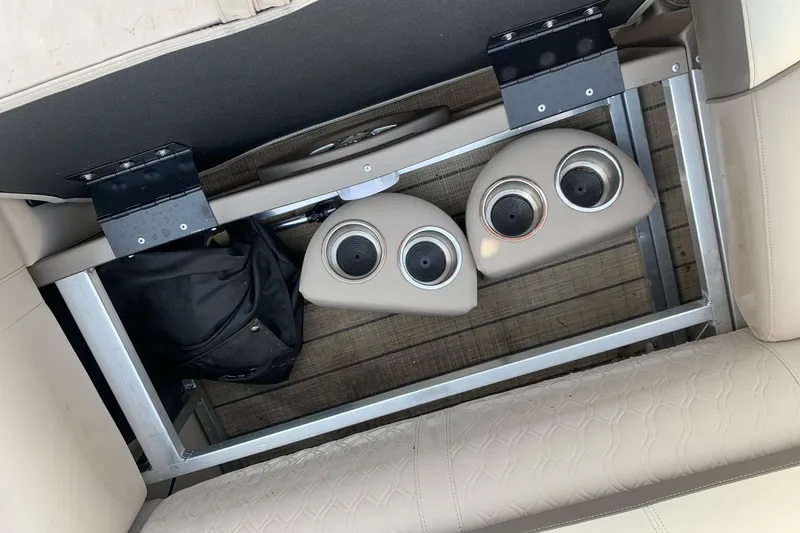 Slide: The Image of 2024 Avalon Catalina Quad Lounge interior storage with cup holders and seating. - 21