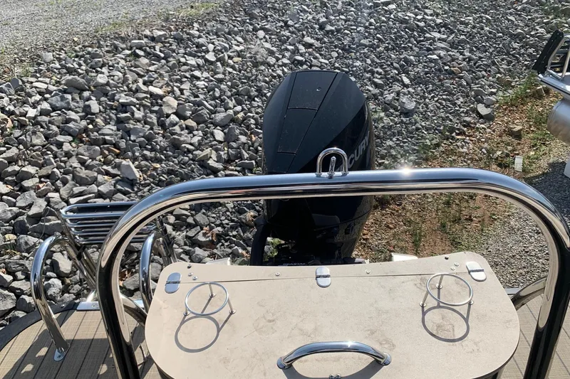 Slide: The Image of 2024 Avalon Catalina Quad Lounge boat with Mercury outboard motor, rear view. - 22