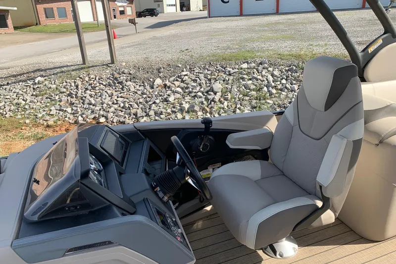 Slide: The Image of 2024 Avalon Catalina Quad Lounge boat interior with modern helm and comfortable seating. - 9