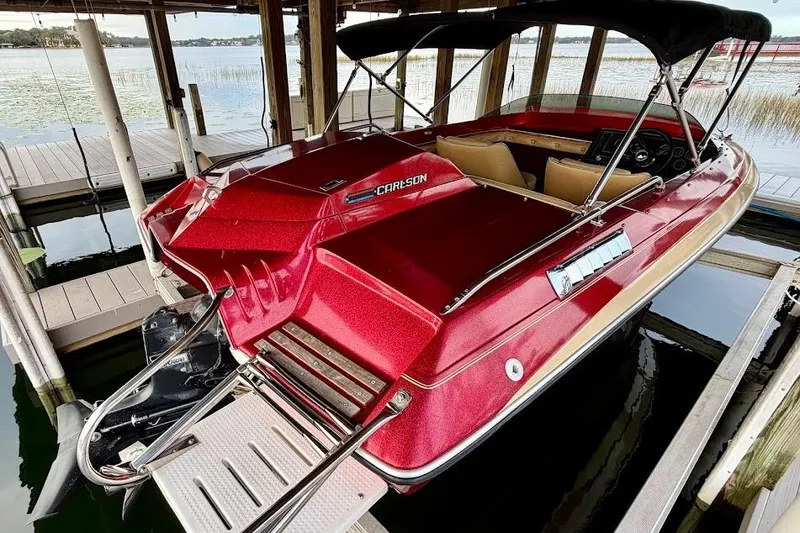 Slide: The Image of Red 1981 Glaston/Carlson C-512 boat docked, featuring sleek design and canopy. - 21