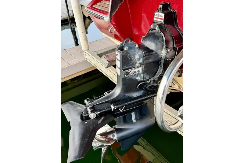 Slide: The Image of 1981 Glaston/Carlson C-512 boat motor with MerCruiser outdrive, docked by water. - 22
