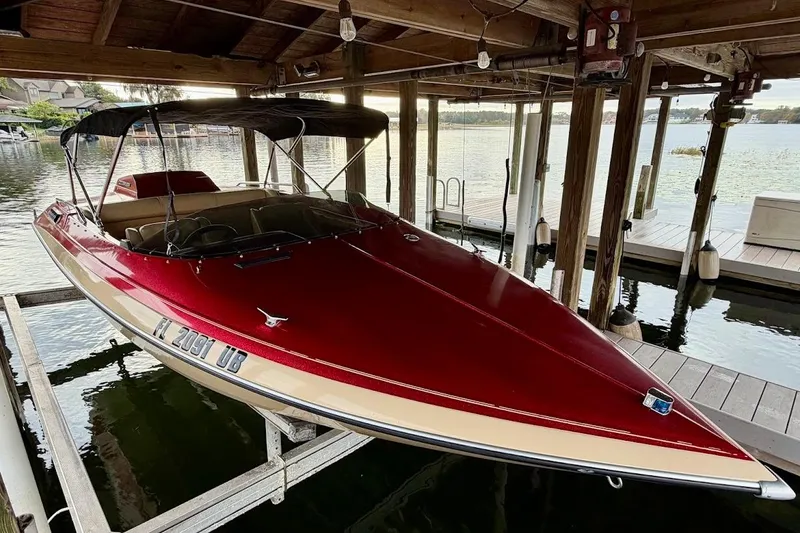 Slide: The Image of 1981 Glastron Carlson boat in a covered dock. - 25