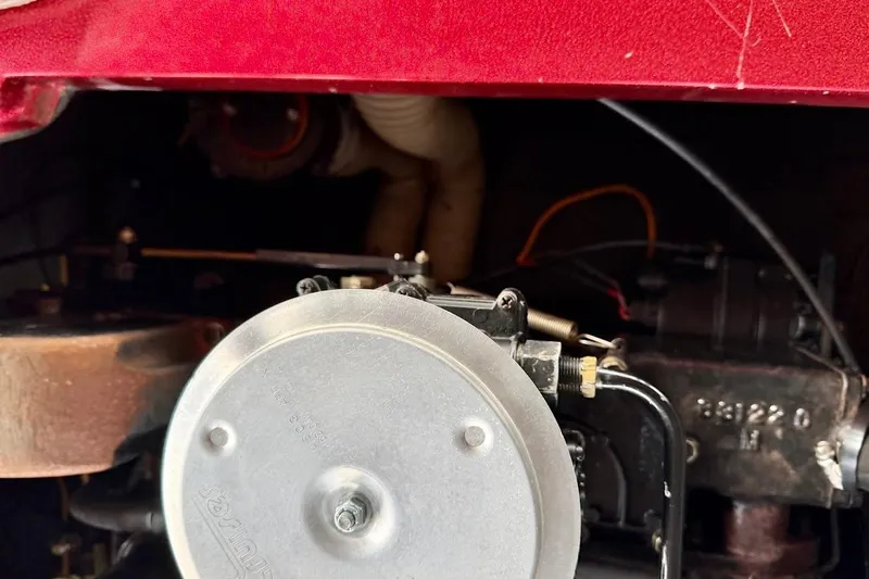 Slide: The Image of Close-up of a 1981 Glaston/Carlson C-512 engine component with visible wiring and metal parts. - 28