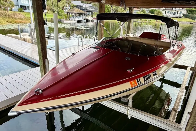 Slide: The Image of 1981 Glaston/Carlson C-512 boat docked on a serene waterfront. - 3