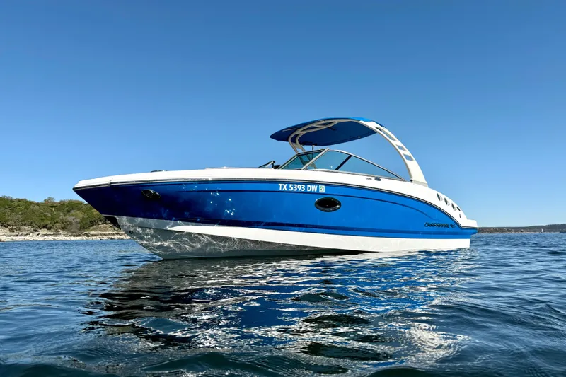 The Image of 2017 Chaparral 246 SSi boat on calm water under clear blue sky. - 1