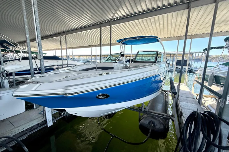 Slide: The Image of 2017 Chaparral 246 SSi boat docked under a covered marina. - 10
