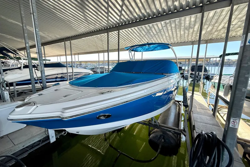 Slide: The Image of 2017 Chaparral 246 SSi boat docked under a covered marina. - 14