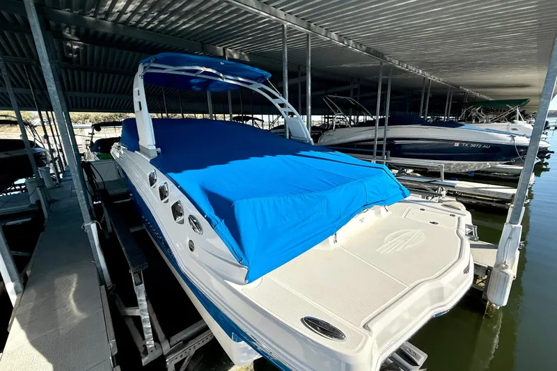Slide: The Image of 2017 Chaparral 246 SSi boat with blue cover docked in marina. - 15