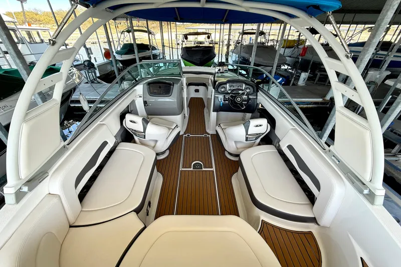 Slide: The Image of 2017 Chaparral 246 SSi boat interior with white seating and wood-style flooring. - 18