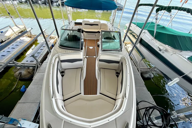 Slide: The Image of 2017 Chaparral 246 SSi boat docked, featuring spacious seating and sleek design. - 19