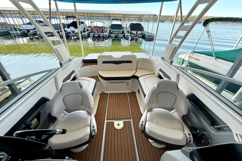 Slide: The Image of 2017 Chaparral 246 SSi boat interior with plush seating and wood-style flooring. - 20