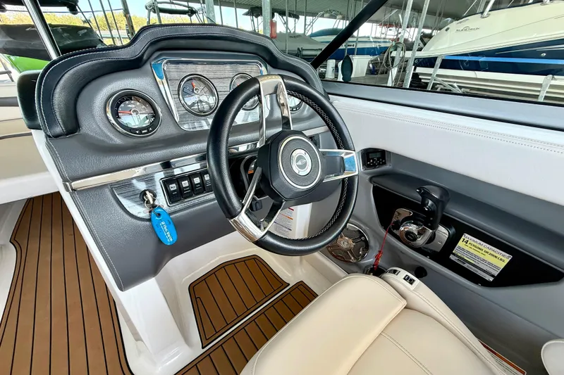 Slide: The Image of Interior view of 2017 Chaparral 246 SSi boat dashboard with steering wheel and controls. - 22