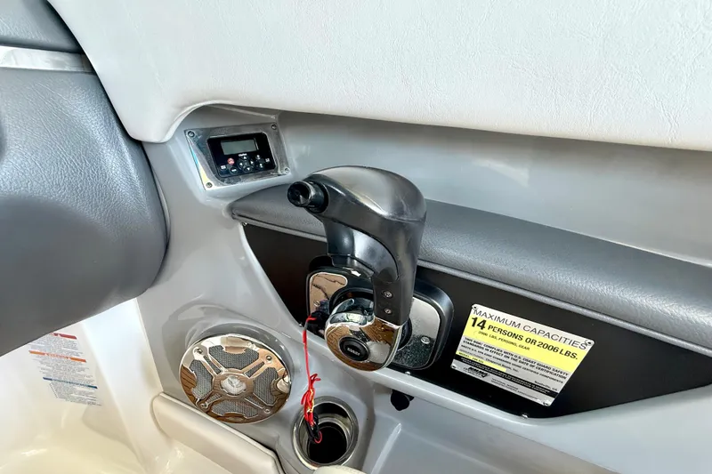 Slide: The Image of Interior of 2017 Chaparral 246 SSi boat showing control panel and capacity label. - 23