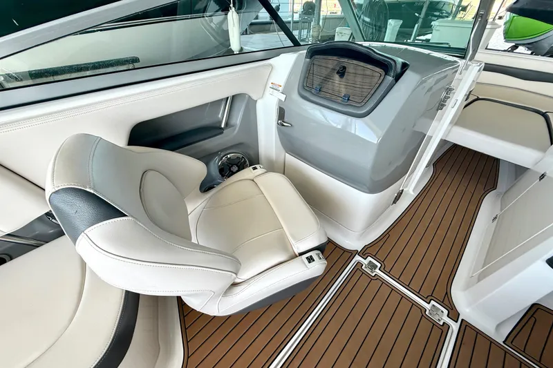 Slide: The Image of 2017 Chaparral 246 SSi boat interior with sleek seating and wood-style flooring. - 24