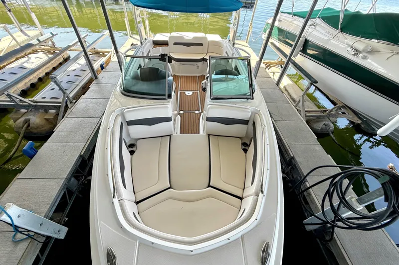 Slide: The Image of 2017 Chaparral 246 SSi boat docked, featuring spacious seating and sleek design. - 26