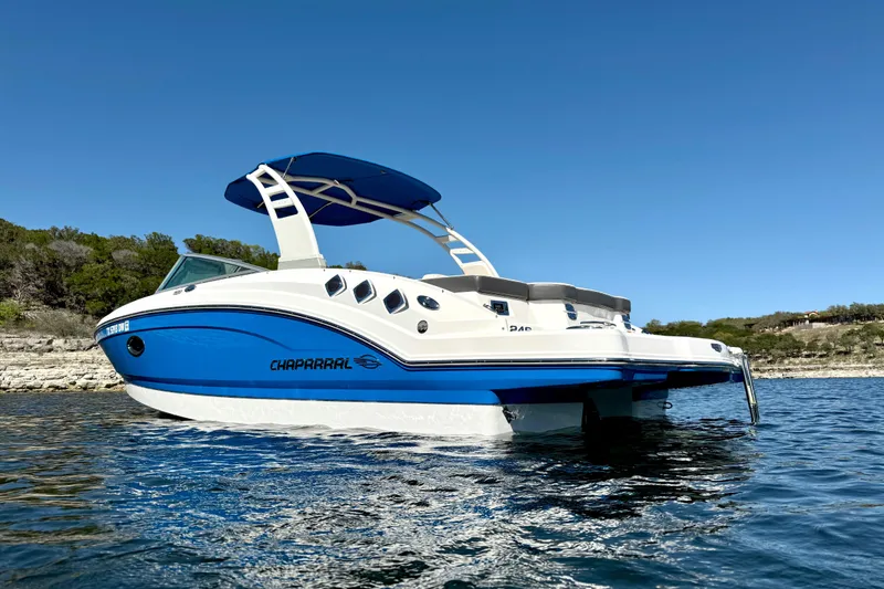 Slide: The Image of 2017 Chaparral 246 SSi boat with blue hull on a sunny lake. - 3