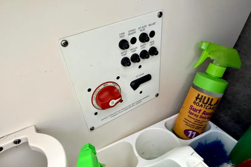 Slide: The Image of Control panel of a 2017 Chaparral 246 SSi boat with cleaning supplies nearby. - 31