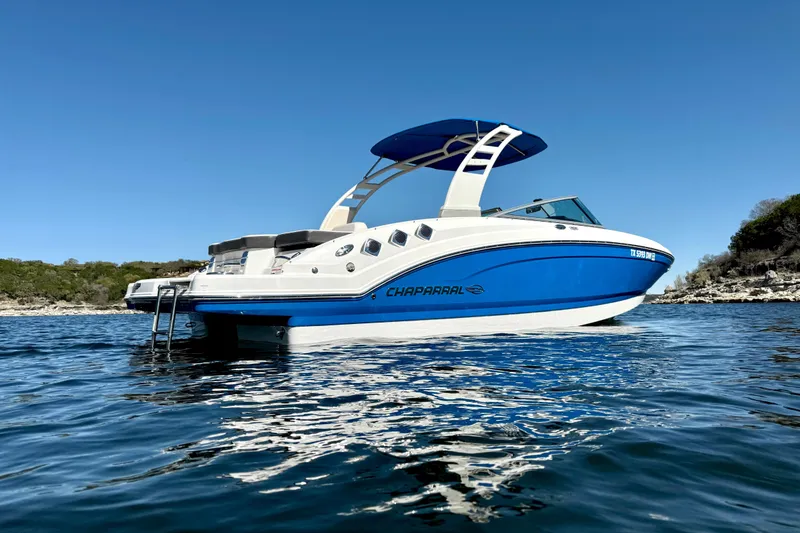 Slide: The Image of 2017 Chaparral 246 SSi boat on calm water under clear blue sky. - 5