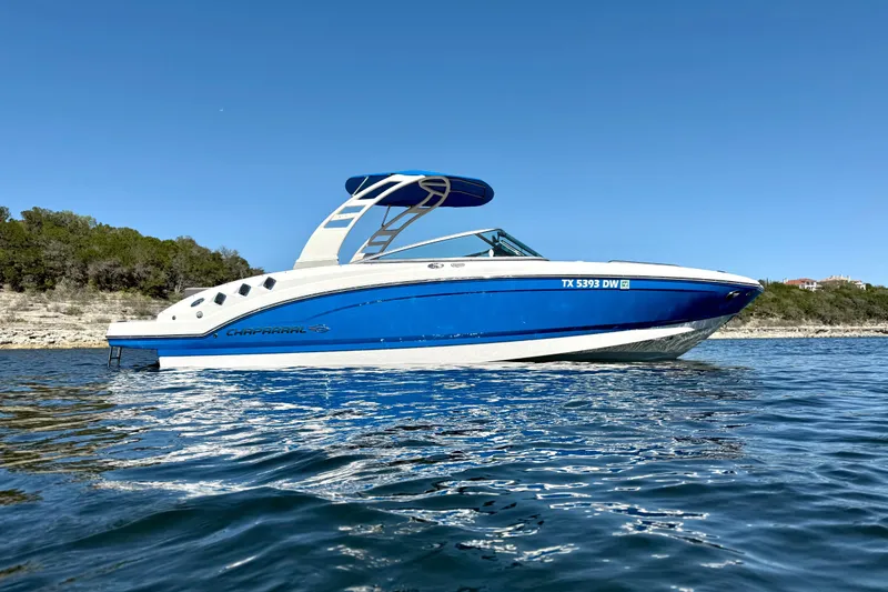 Slide: The Image of 2017 Chaparral 246 SSi boat on calm water with clear blue sky. - 6