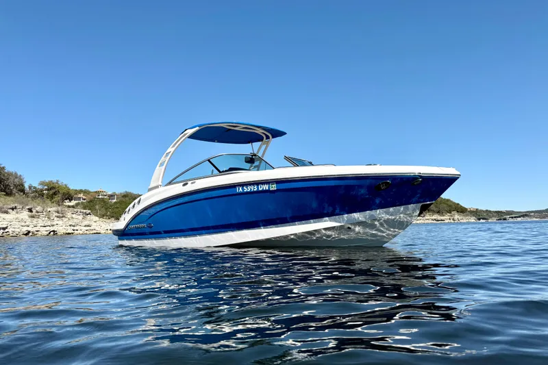 Slide: The Image of 2017 Chaparral 246 SSi boat on calm water under clear blue sky. - 7